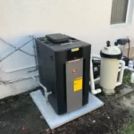 Pool heater, filter, pump, valves, and PVC plumbing installed beside a Central Florida home.