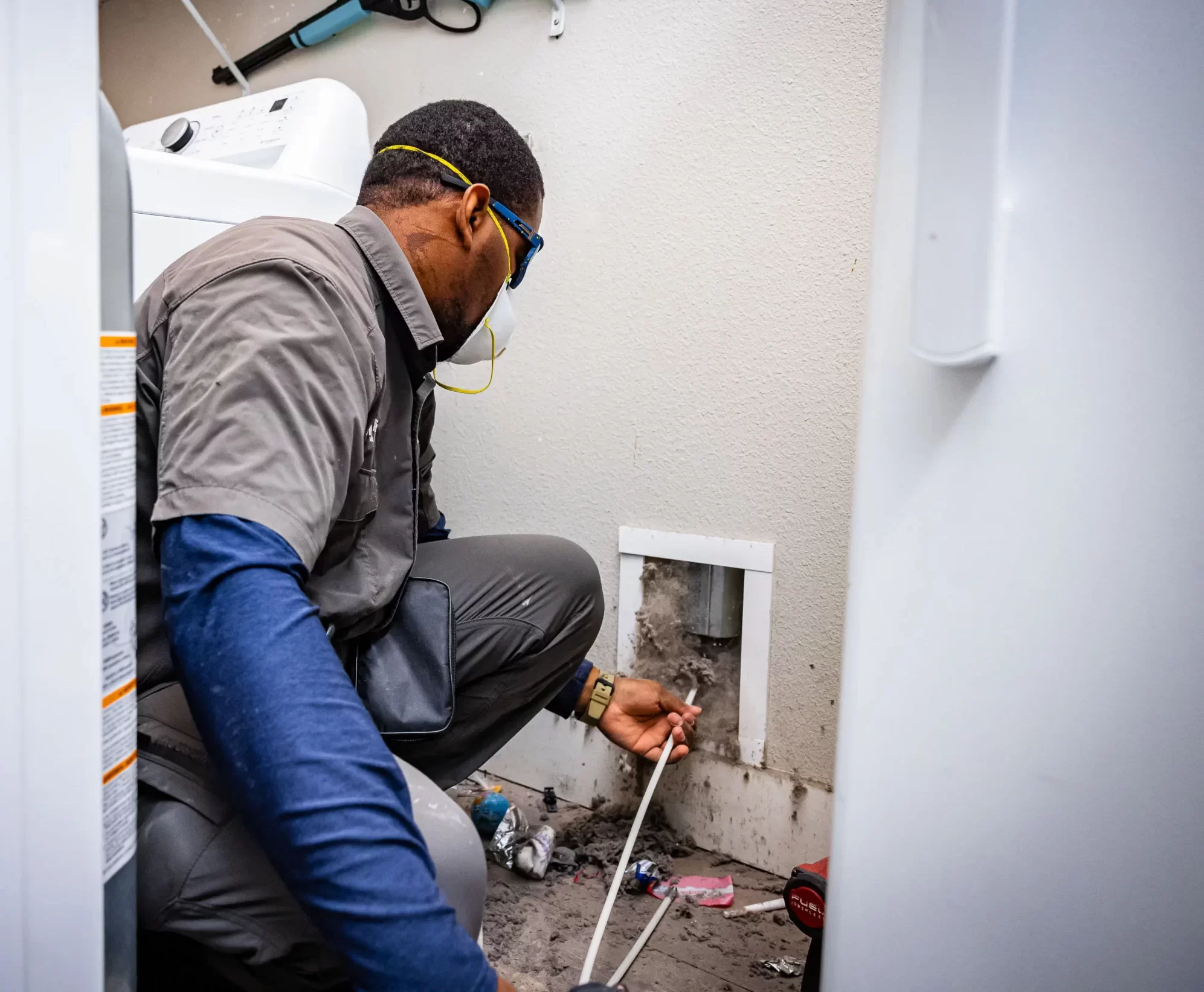 Tech Cleaning behind dryer Vent