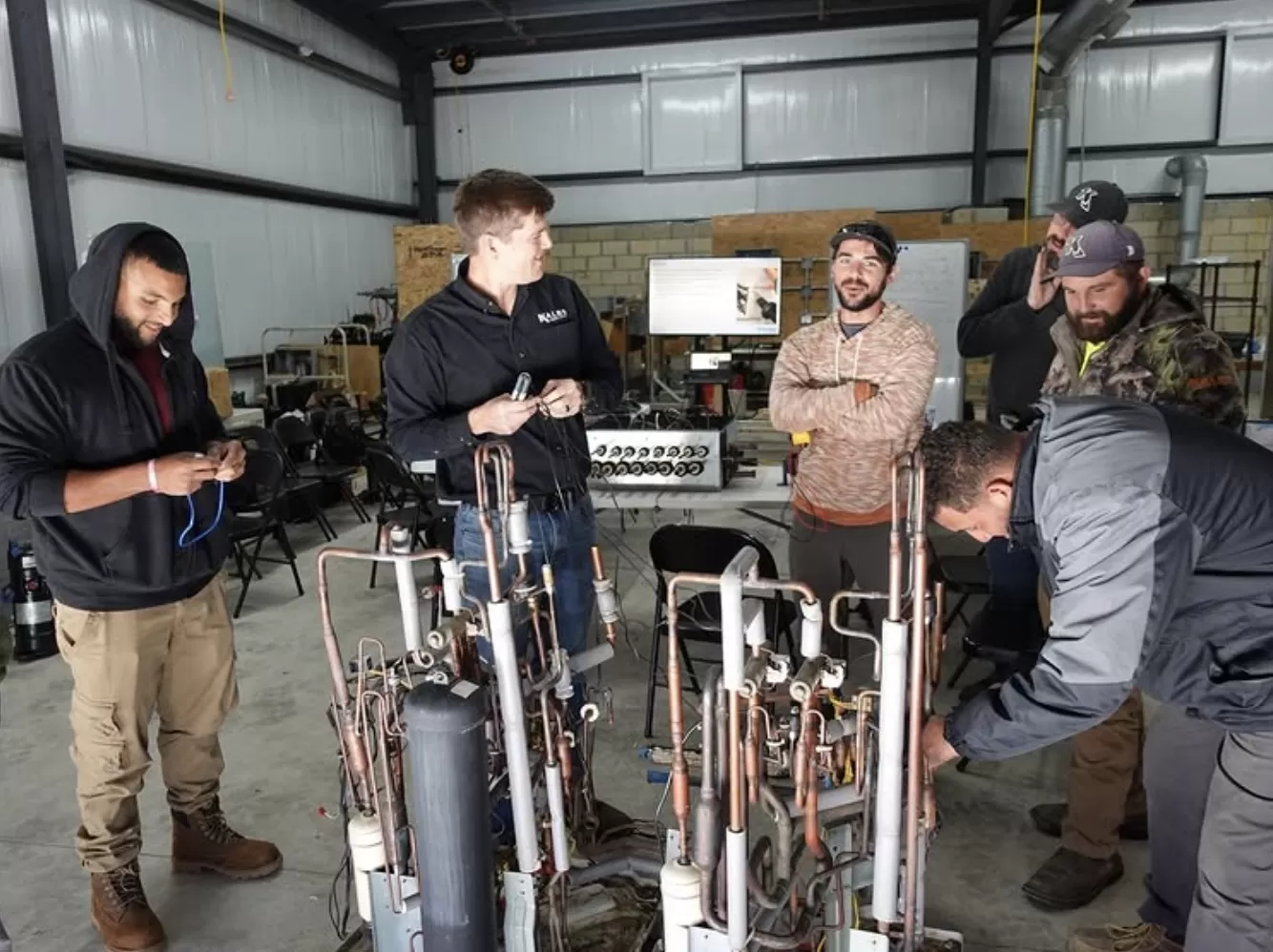 Kalos employees taking part in hands-on HVAC training