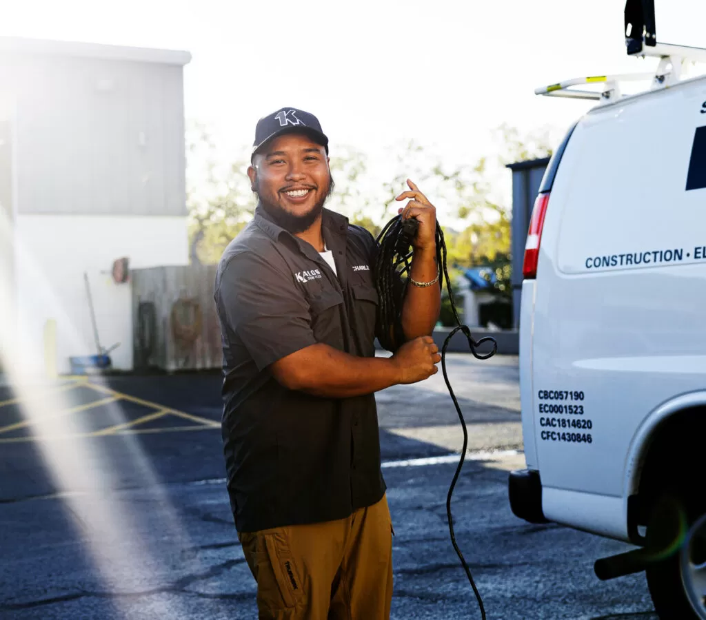 Tech In front of truck, Wrapping Cable