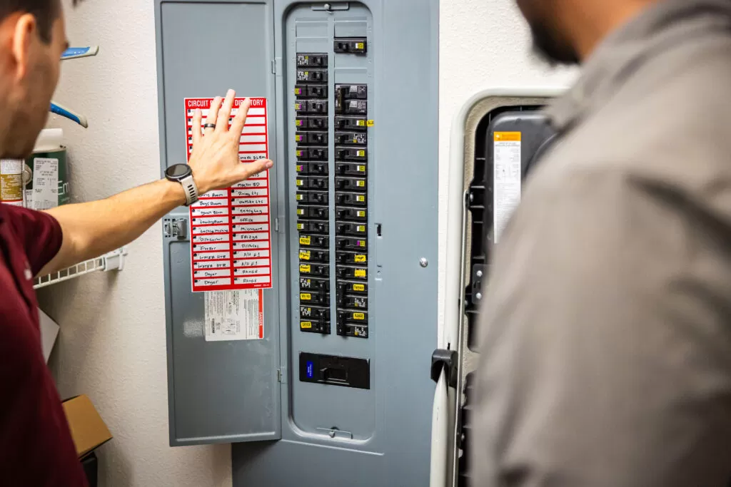 Tech fixing Electrical Panel