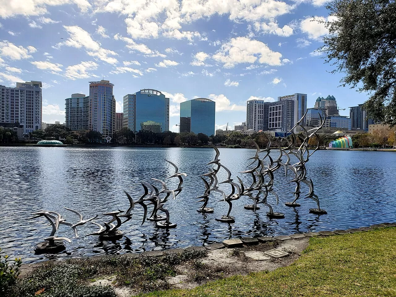 Lake Eola Park and the downtown Orlando skyline on a sunny day.